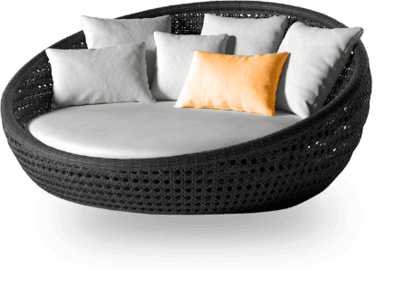 A round couch with pillows on top of it.