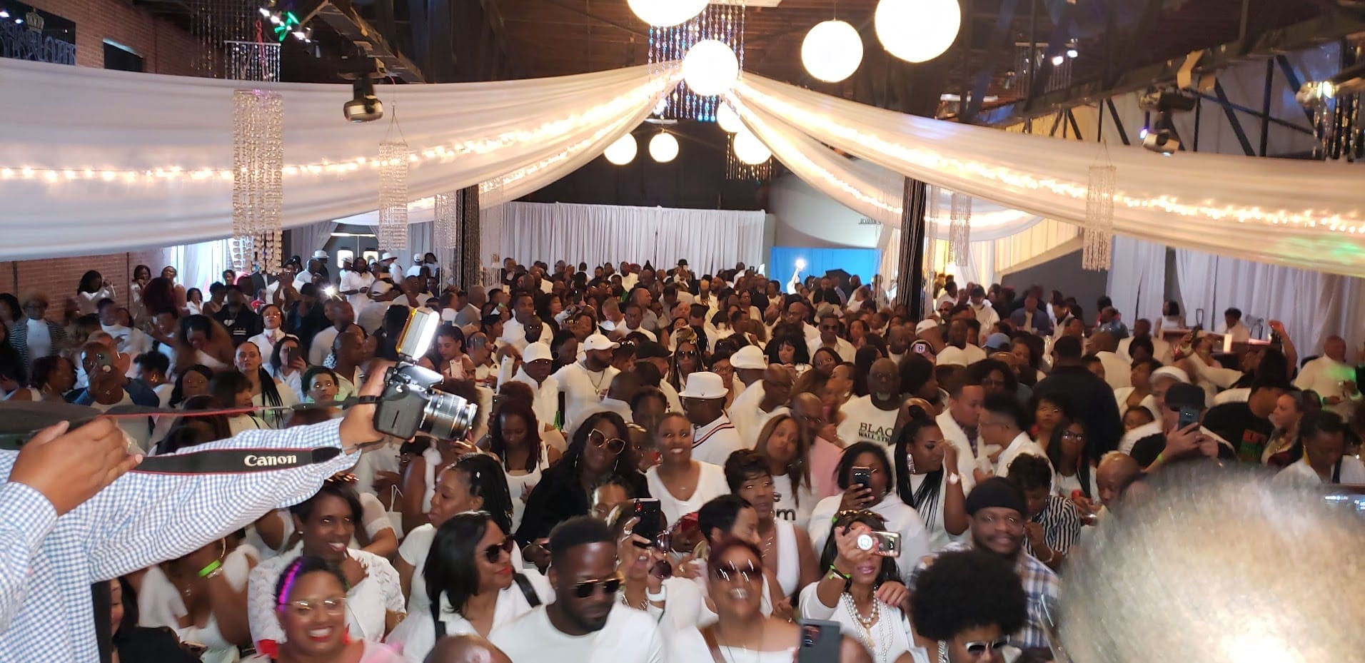 A large group of people in white clothes.